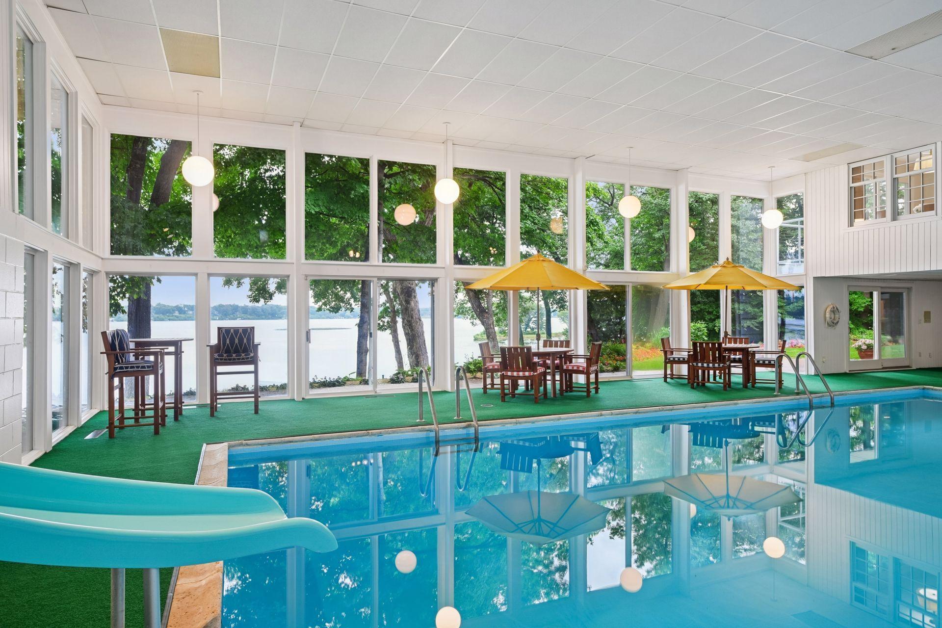 Expansive windows and patio doors open to the backyard and lake beyond
