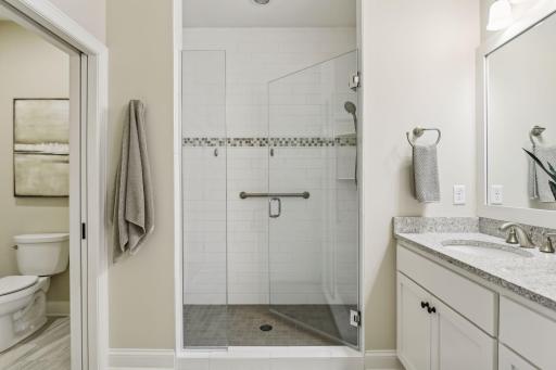 Spacious walk-in shower and private water closet