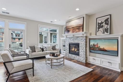 Living space is anchored by a cozy gas fireplace and custom built-ins