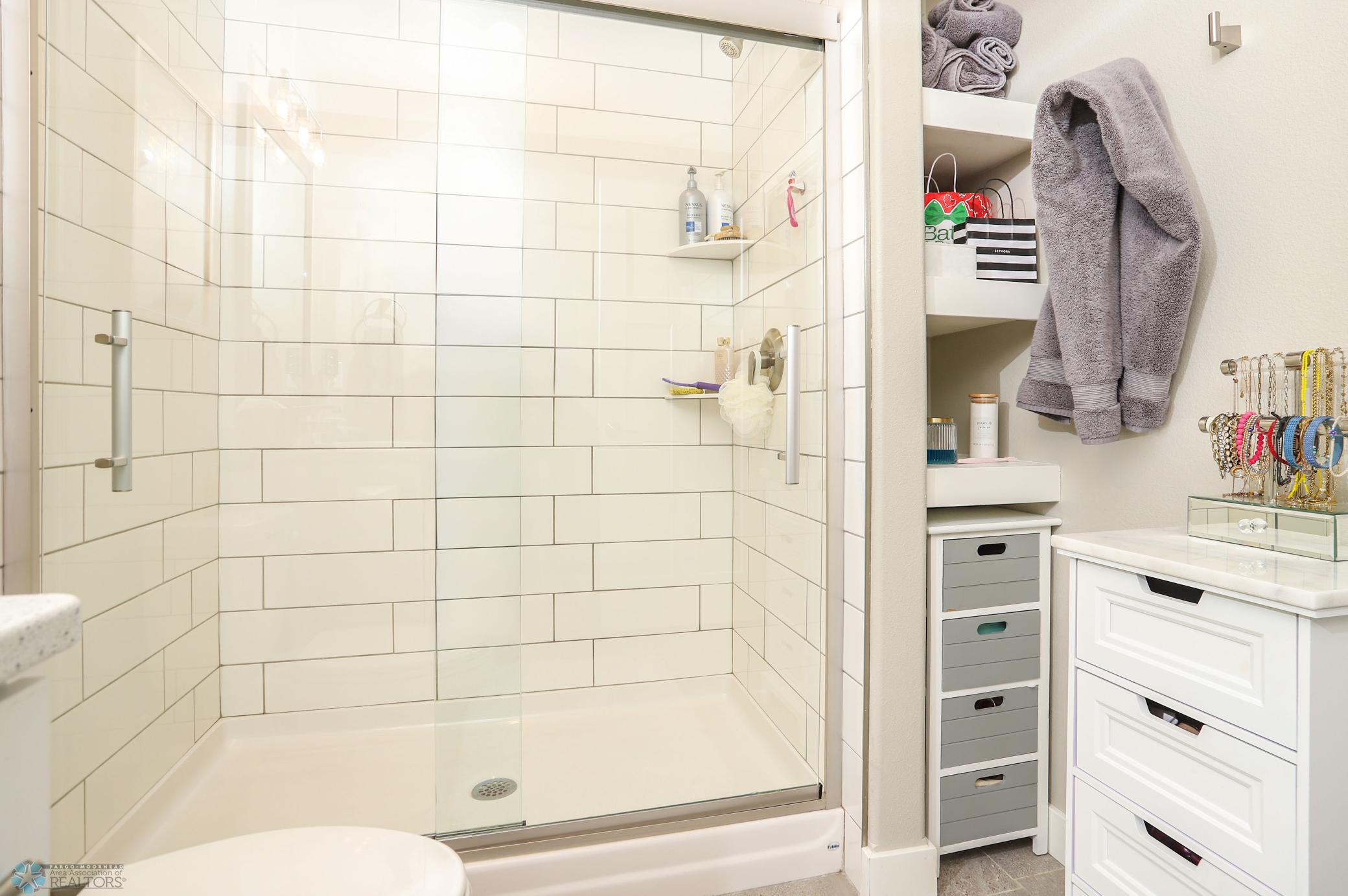 Primary Bathroom (tile shower with glass doors)