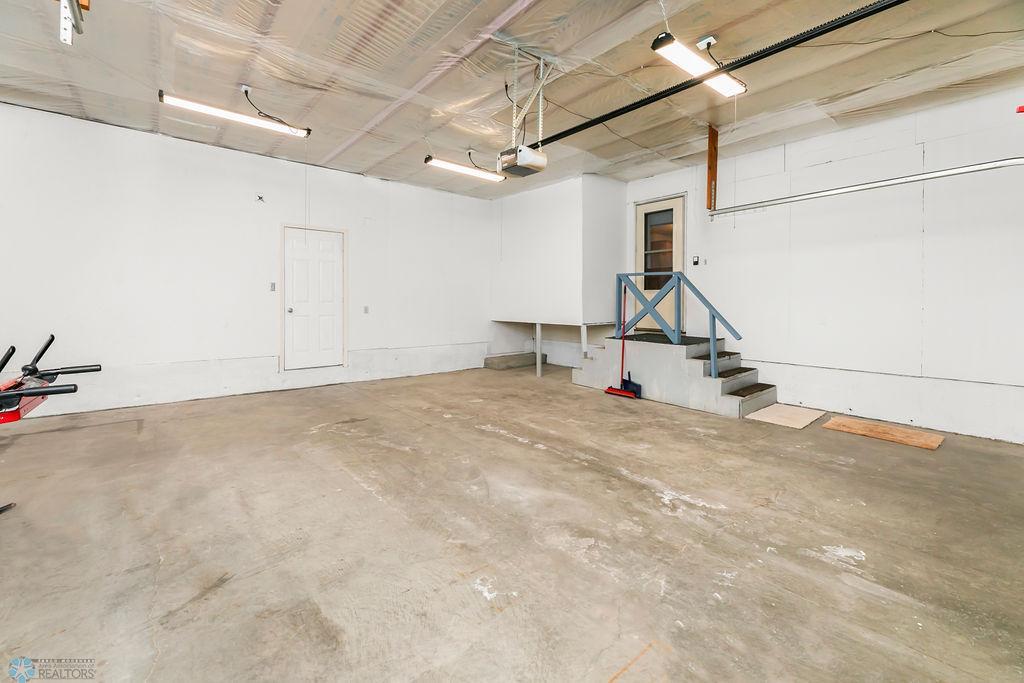 Attached 2-car garage. Entry leads to Back living room.