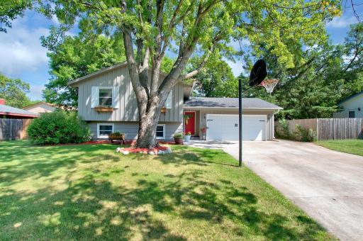 A summer view of this charming home. Note the concrete driveway. This photo was taken a couple of years ago and the door is no longer red.