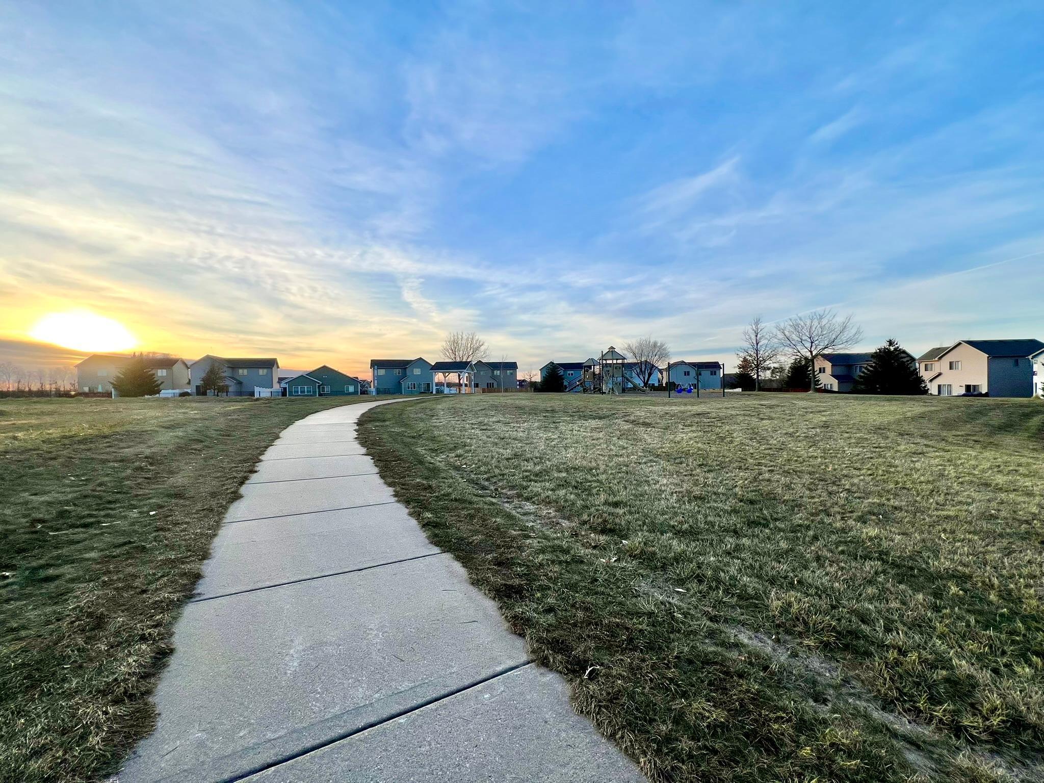 Path to playground and park across the street from lot.
