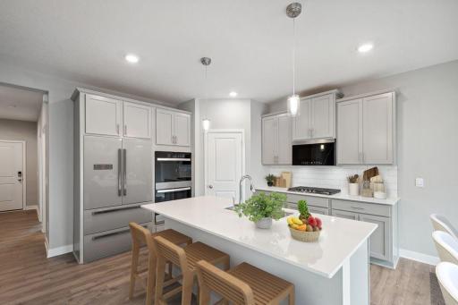 Kitchen has ample counter and cabinet space. The perfect space for making everyday meals or memorable special occasion dinners. Photos used are from a model of a similar plan/home representation. Some colors and options will vary.