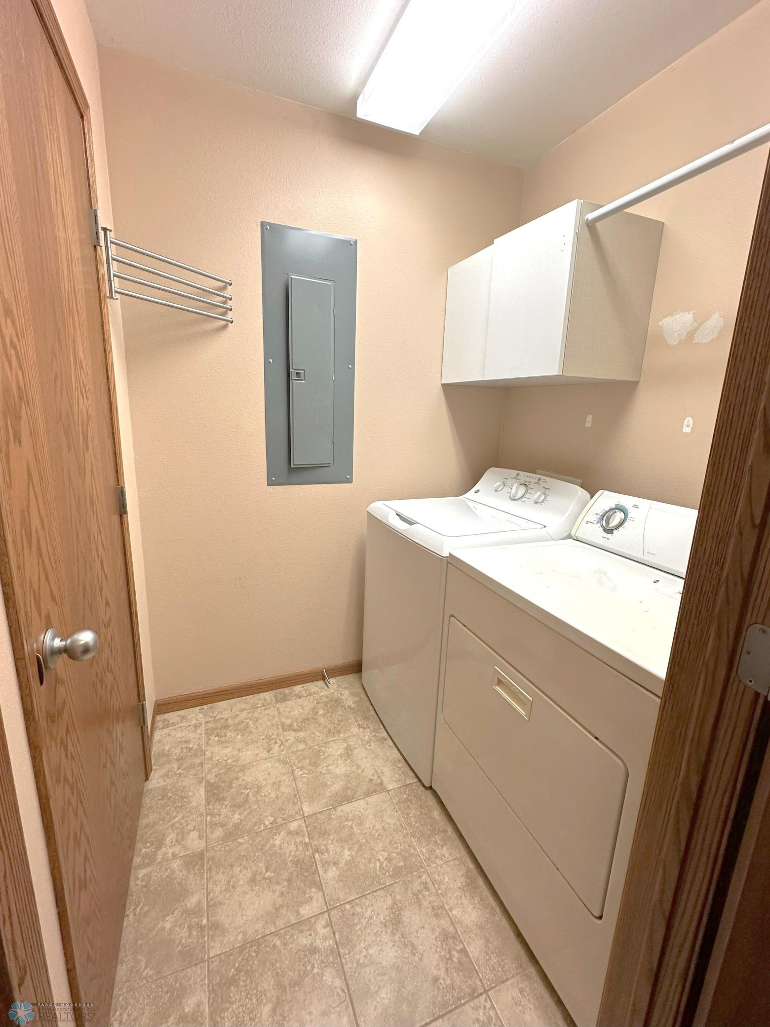 Separate Laundry Room with Cabinet & Hanging Rod