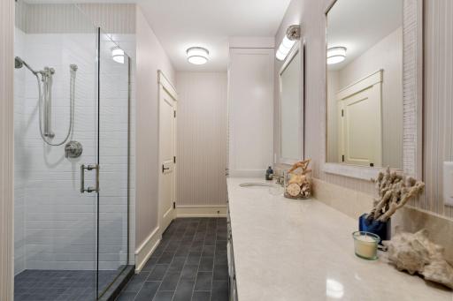 Situated by the lower level Bedroom is a 3/4 Bathroom with furniture style vanity, classic subway tiled shower and heated tile flooring.