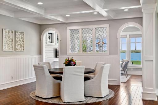 A versatile dining room designed for both intimate weekly meals and special celebrations, featuring elegant enameled wainscoting and a classic box beam ceiling that adds timeless charm.