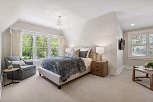 The second Junior Bedroom suite on the upper level enjoys views of the backyard.