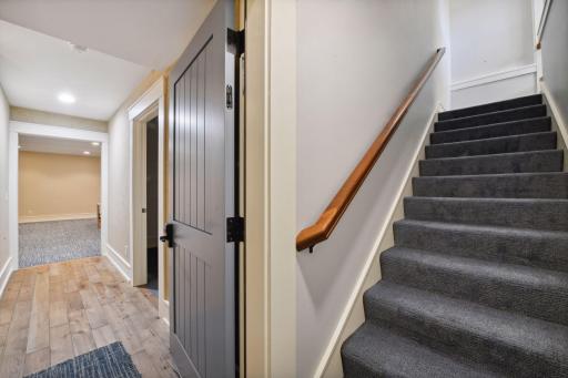 Two large, finished storage rooms complete the lower level - this staircase leads to up to the garage.