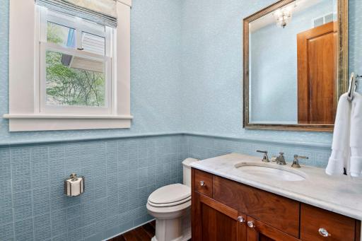 The Powder Room features a custom tile selection and designer wall coverings.