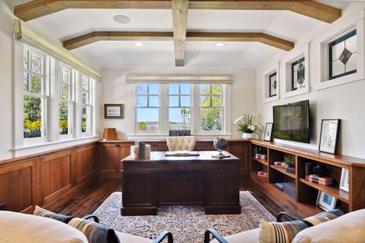 This executive home office boasts wall-to-wall walnut built-ins and beautiful views, creating a refined and focused space for productivity and creativity.