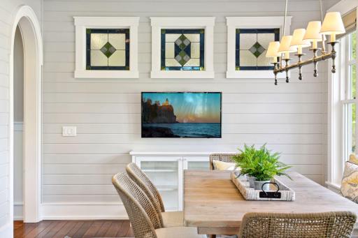 Custom leaded glass windows by Gaytee-Palmer Stained Glass add a touch of artistry to the main level living spaces.