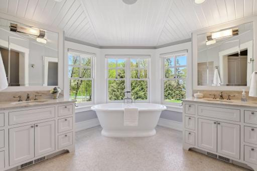 Indulge in spa-worthy luxury in the Primary Bathroom, featuring non-slip heated Afyon marble tile floors, a sculptural Victoria + Albert soaking tub, and dual vanities for everyday ease.