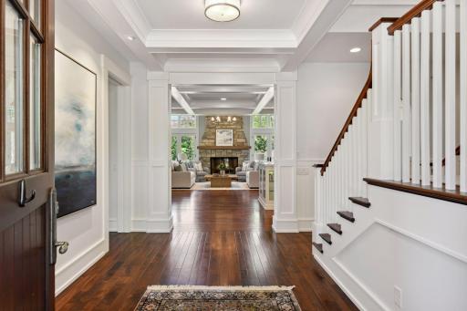 Step through the custom mahogany front door to discover beautiful millwork, box beam ceilings and gorgeous hardwood floors that flow throughout the home.