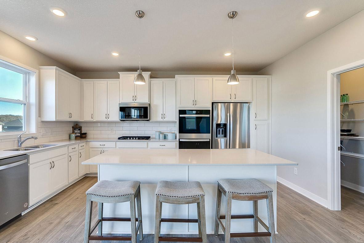 Quartz countertops and stunning backsplash in this wonderful kitchen! Welcome to the family chef's dream kitchen!! (Photo of model, colors may vary)