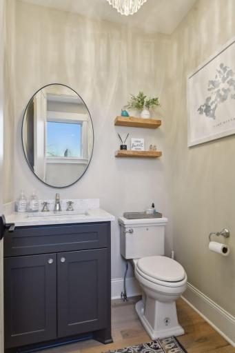 Stylish main floor powder bath featuring elegant floating shelves for a modern touch.