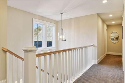 Upper-level hallway, offering easy access to bedrooms and additional living spaces.
