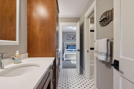 Upper level bathroom conjoining two bedrooms. Features two sinks and ample storage space