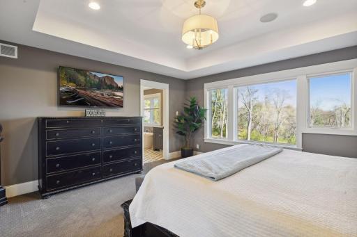 Primary bedroom bathed in natural light, offering a bright and serene retreat.