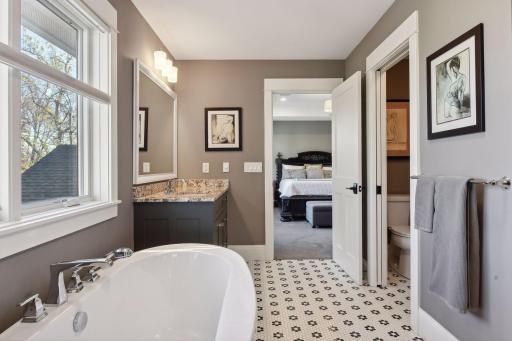 Step into the full ensuite bathroom: featuring electric heated floors, a relaxing soaker tub, and a separate shower
