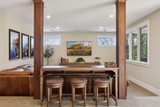Just outside the lower level windows, a screened-in porch awaits, offering the perfect setting for an outdoor hot tub experience