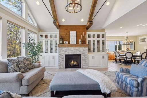 Living room features sophisticated built-ins and a seamlessly integrated TV that rises from the cabinetry