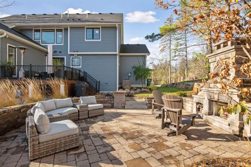 Step down into this private sanctuary, featuring a charming wood-burning stone fireplace