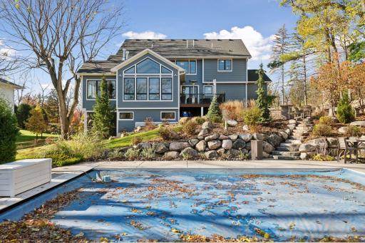 The walkout leads to the patio and pool area, ideal for outdoor living and entertaining (pool, boulder wall, extensive landscaping added in 2018)