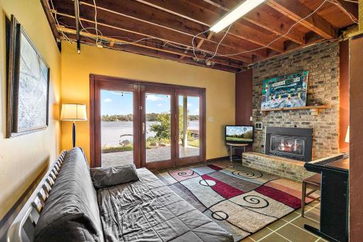 Walkout lower level with Chicago-brick gas fireplace and French doors offering a great view of Lower Prior Lake.