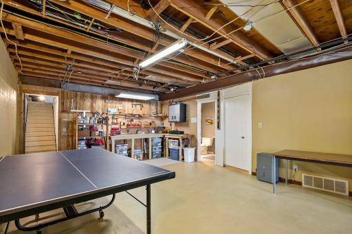 Stairs from garage leads to lower-level space. Three-quarter bath at right of photo.