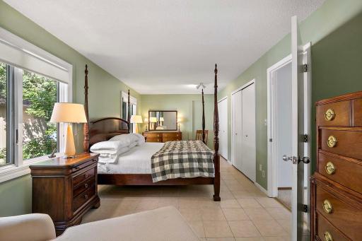 Oversized bedroom on upper level has multiple closets and tile floors.