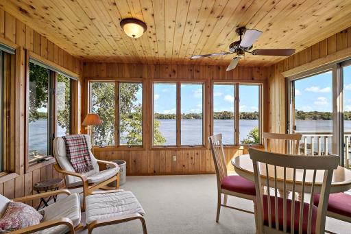 Feel the comfort of the wool carpet and pad in this cedar-paneled three-season sunroom with amazing views of Lower Prior, sliding door to deck.