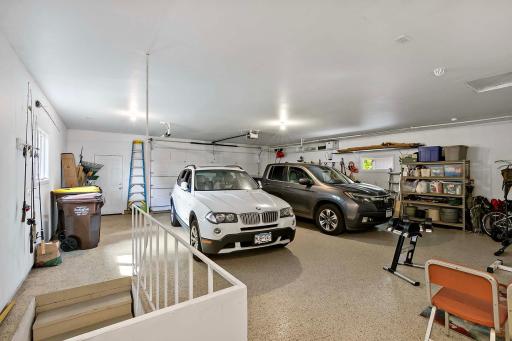 900-square-foot insulated garage with epoxy flooring. Easily park a car, truck and more in this garage. Stairs lead to lower-level of home.