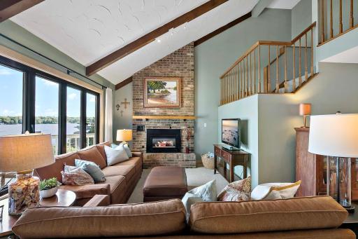 Cozy lakeside great room with Chicago brick gas fireplace and vaulted ceilings.