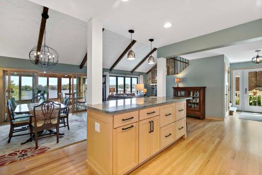 Kitchen opens up to dining and great room area with vaulted ceilings with exposed cedar beams. Complete with lake views!