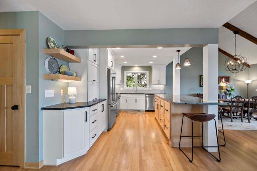 Renovated gourmet kitchen shines with custom thermal-baked enameled cabinetry, undermount lighting, stainless steel Beko appliances, granite and Brazilian quartzite countertops.