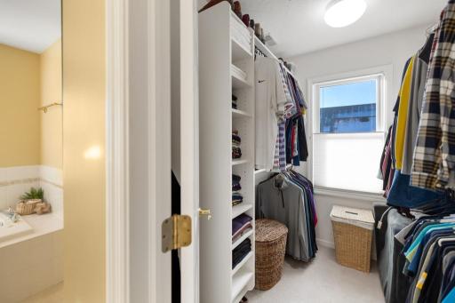 The walk-in closet provides plenty of space for your wardrobe and professional organization system ensures everything has its place.