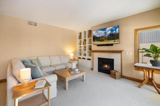 Custom built-ins flanking the gas fireplace provide both visual appeal and functional storage, providing space for both decorative accents and everyday essentials.