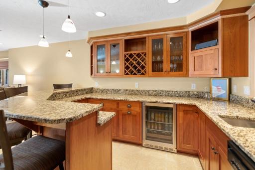 Featuring elegant granite countertops and cherry cabinets with glass fronts â perfect for showcasing your favorite glassware, liquor or mixology essentials.