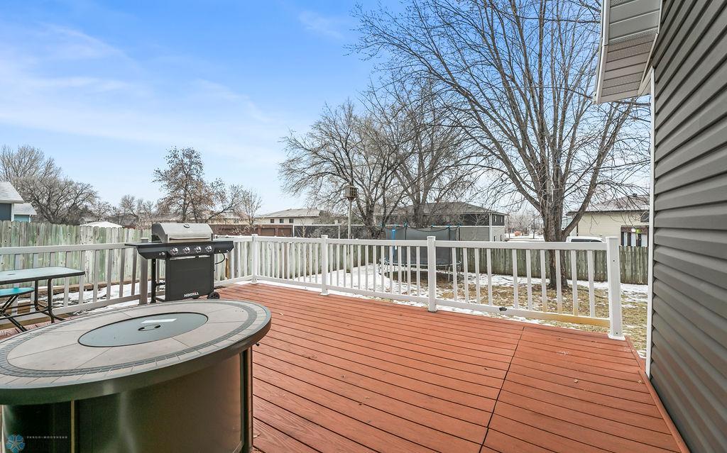 Large deck overlooking fenced backyard
