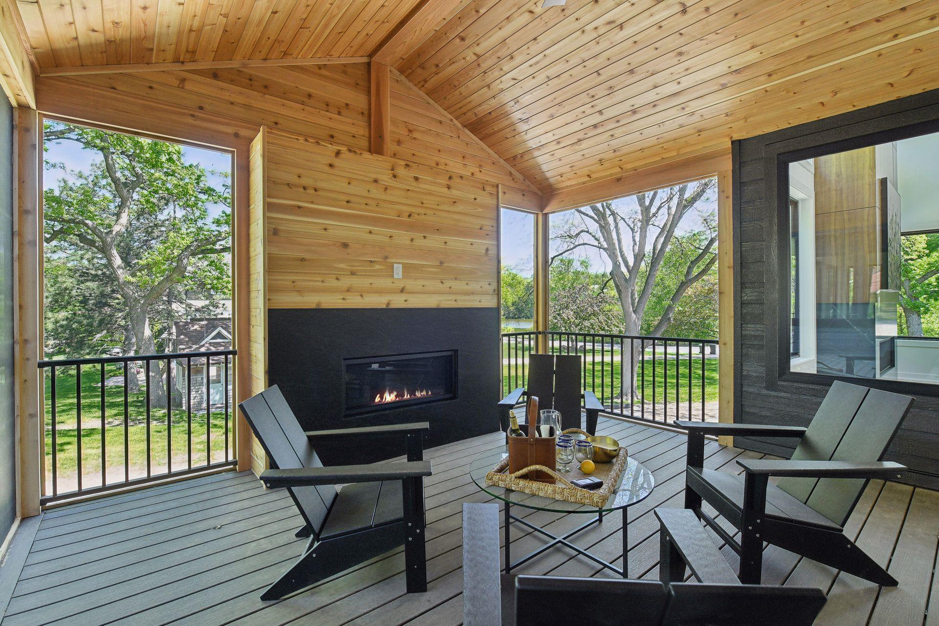 A three-season vaulted outdoor lliving space offering a up north experience you can enjoy everyday complete with a gas fireplace.