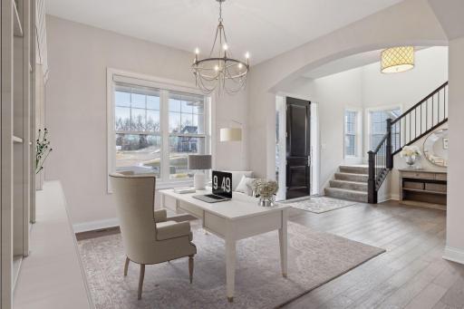Property has been virtually staged as an office. The front door opens to reveal an open-concept layout with main floor office or dining room.