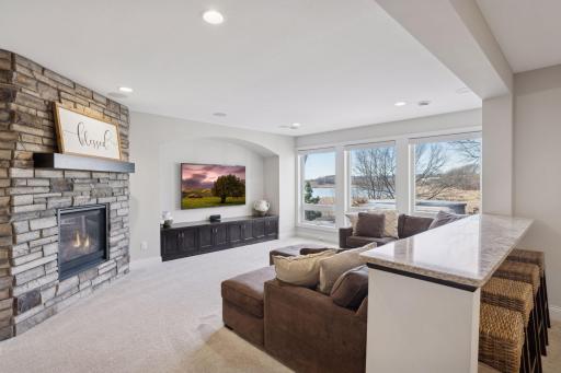 The walkout lower level highlights a family room with gas fireplace, wine cellar, wet bar, game area, fifth bedroom, and 30 x 22 indoor sport court.