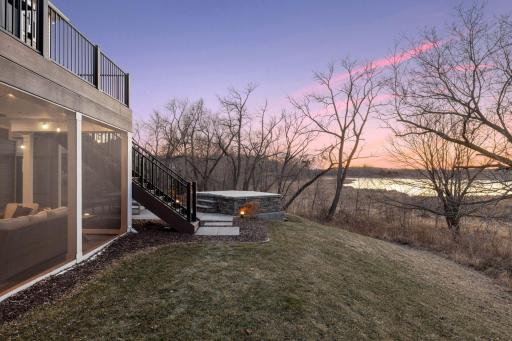 Outdoor amenities include a screened porch, swim spa, deck, professional landscaping, sweeping pond views, and spectacular sunsets.
