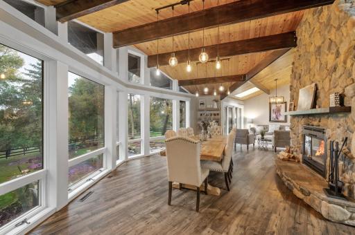 dining room between the 2 living rooms with floor to ceiling wood burning fireplace