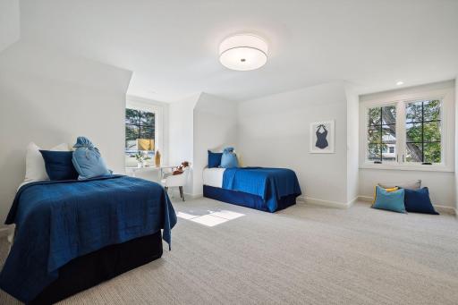 This inviting guest bedroom provides a perfect haven for visitors, featuring comfortable furnishings and a warm ambiance.