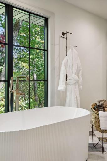 Unwind in this exquisite soaking tub, nestled in the luxurious primary bath. Designed for relaxation, it offers the perfect escape to indulge in self-care and tranquility, making every bath a rejuvenating experience.