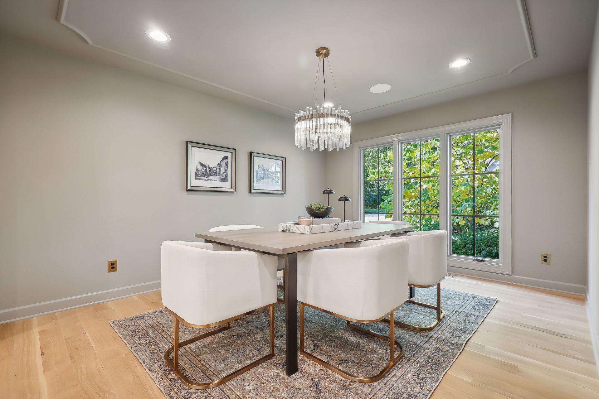 This stunning dining room features elegant tray ceiling details that add depth and character to the space.