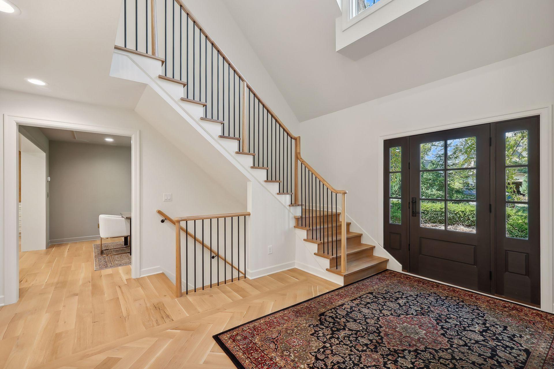 This spacious foyer features beautiful light wood floors and ample storage, seamlessly combining elegance and practicality. The open design welcomes you home with warmth and charm, making a lasting first impression.