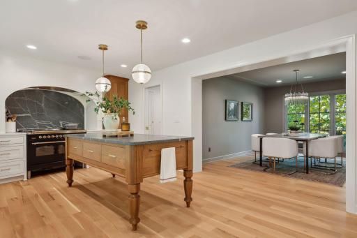 This beautiful wood island is complemented by honed granite countertops, offering a perfect blend of warmth and sophistication. Ideal for meal prep or casual dining, this centerpiece enhances both functionality and style in the kitchen.